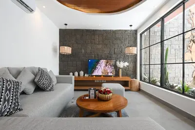a living room with a couch and a table at The Wina Villa Canggu by The Wina Resorts in Canggu
