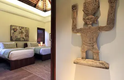 a room with a statue of a cross on the wall at Villa Suar Drupadi in Seminyak