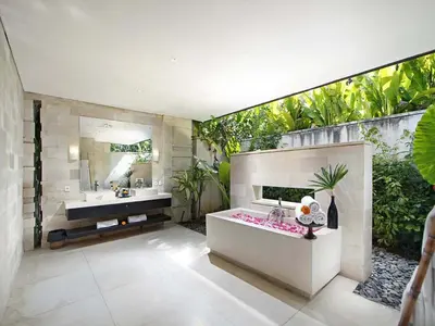 a bathroom with a sink and a mirror at Villa Mona in Canggu