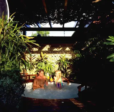 two men in a jacuzzi in a pool at Poppies Bali in Kuta