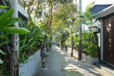 a street in a resort with trees and plants at Grand Kesambi Resort and Villas Seminyak in Seminyak