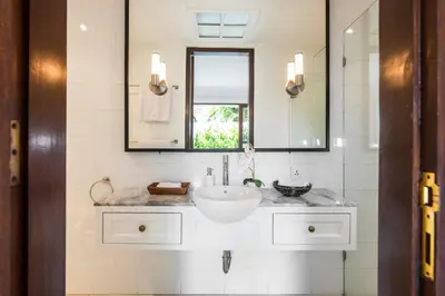 a bathroom with a sink and a mirror at Villa Atma 2BR Fully Equipped Kitchen in Seminyak