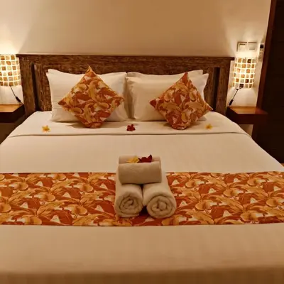 a hotel room with a bed with towels on it at Villa Sammy in Seminyak