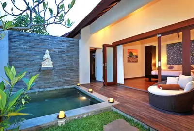 a house with a pool in the yard at Desa Di Bali Villas in Kerobokan