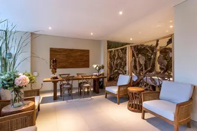 a living room with a table and chairs at Desa Di Bali Villas in Kerobokan