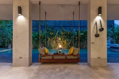 a living room with a couch in front of a large window at Villa Saba 10 in Seminyak