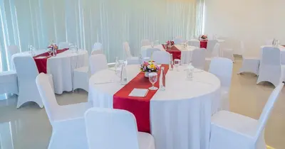 a room with white tables and white chairs at Swiss-Belinn Seminyak in Seminyak