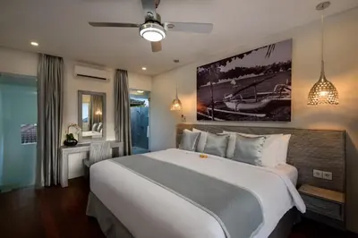 a bedroom with a large bed in a room at Villa Ozamiz Seminyak in Seminyak