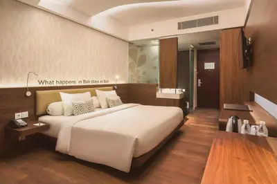 a bedroom with a large white bed in a room at Infinity8 Bali in Jimbaran