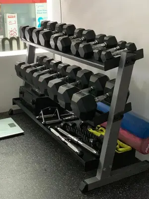 a gym with two rows of dumbbells on a rack at Kamil Villas in Seminyak