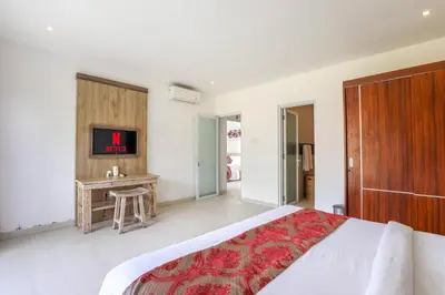 a bedroom with a large bed and a desk at Puri Bagus Villa by Great Bali Villas in Legian