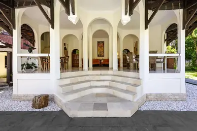 an indoor patio of a house with a stone floor at Cove Urbanest Inn in Seminyak