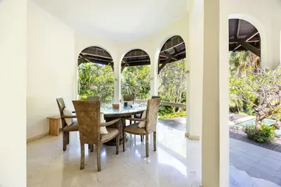 a dining room with a table and chairs at Cove Urbanest Inn in Seminyak