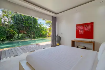 a bedroom with a bed and a large window at Gorgeous Tropical 3 Bed Pool Villa, 24hr Security in Seminyak