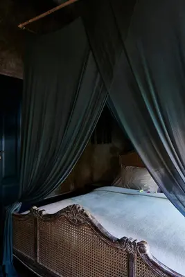 a bedroom with a canopy with a bed with white sheets at The Island Houses Seminyak in Seminyak