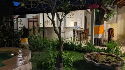 a garden with a tree in the middle of a building at Ben Bali Villa in Seminyak