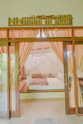 a bedroom with a bunk bed with a canopy at Ben Bali Villa in Seminyak