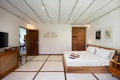 a bedroom with a bed and a tv in a room at Best Location, 9 Bedr Pool Villa, Close To Beach in Seminyak