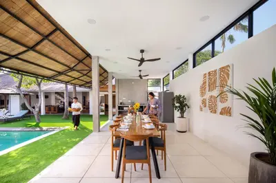 a dining room with a table and a pool at Best Location, 9 Bedr Pool Villa, Close To Beach in Seminyak