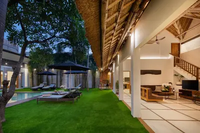an outdoor living room with a pool and grass at Best Location, 9 Bedr Pool Villa, Close To Beach in Seminyak
