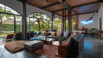 a living room with a couch and a table at NicoNico Mansion by Villa Finder in Seminyak