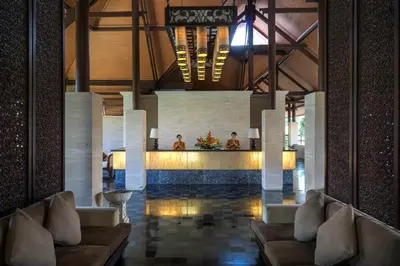 a lobby with couches and a bar in a building at Grand Balisani Suites Hotel in Seminyak