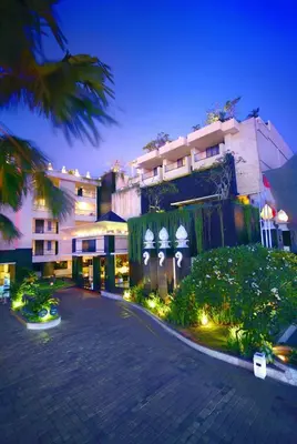 a night view of a building with a parking lot at Aston Kuta Hotel and Residence in Kuta
