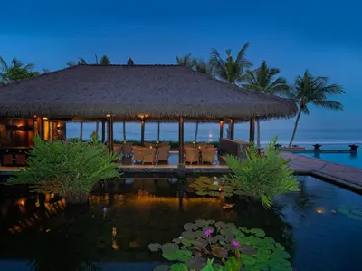 a resort with a swimming pool and a pavilion at The Legian Seminyak, Bali in Seminyak