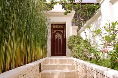 a front door of a house with grass at The Royal Santrian in Nusa Dua