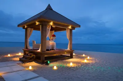 a gazebo with a table and chairs on the beach at The Royal Santrian in Nusa Dua