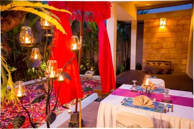 a dining room with a table with candles on it at Aria Exclusive Villas & SPA in Seminyak