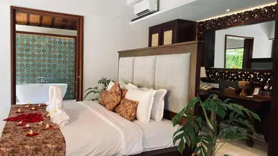 a bedroom with a bed with white sheets and pillows at Aria Exclusive Villas & SPA in Seminyak