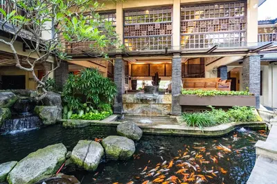 a koi pond in front of a building at Risata Bali Resort & Spa in Kuta