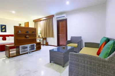 a living room with a couch and a table at Abi Bali Resort and Villa in Jimbaran