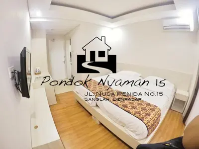 a bedroom with a bed with a house sticker on it at Pondok Nyaman 15 in Denpasar