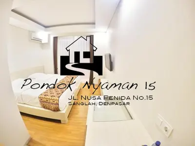 a bedroom with a sign that reads pomodoro mauritania is at Pondok Nyaman 15 in Denpasar