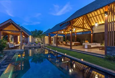 an exterior view of a house with a swimming pool at Villa Meliya in Canggu