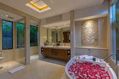 a bathroom with a tub filled with red roses at Villa Meliya in Canggu
