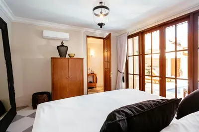 a bedroom with a bed and a large window at Villa Soleh in Seminyak