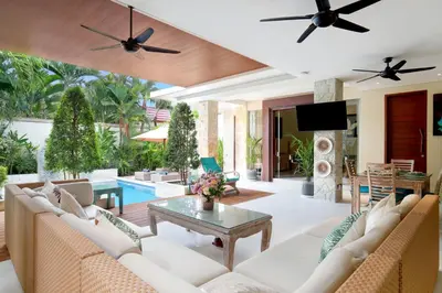 a living room with a couch and a table at Villa J Deluxe in Canggu