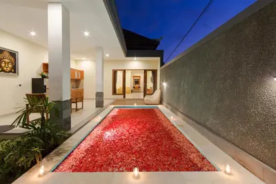 a large pool of red gravel in the middle of a house at Paisa Villa Seminyak in Seminyak
