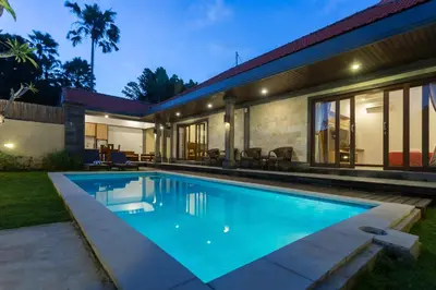 a swimming pool in the backyard of a house at Paisa Villa Seminyak in Seminyak