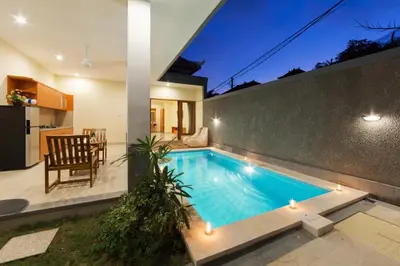 a swimming pool in the backyard of a house at Paisa Villa Seminyak in Seminyak