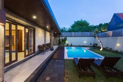 a swimming pool in the backyard of a house at Paisa Villa Seminyak in Seminyak