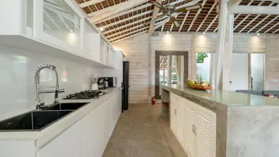 a kitchen with a sink and a counter top at Villa Taramille by Villa Finder in Kerobokan