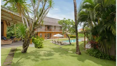 an image of a resort with a pool and palm trees at Villa Alea by Villa Finder in Kerobokan