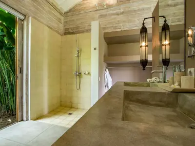 a bathroom with a shower and a sink at Villa Mannao by Villa Finder in Kerobokan