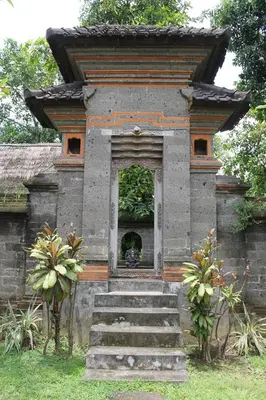 a small building with stairs leading to a doorway at Puri Kutat Lestari in Sanur