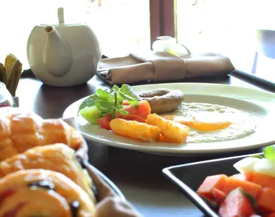 a table with two plates of food on a table at Golden Tulip Jineng Resort Bali in Kuta