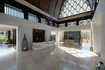 a large living room with a large window and a lobby at Golden Tulip Jineng Resort Bali in Kuta